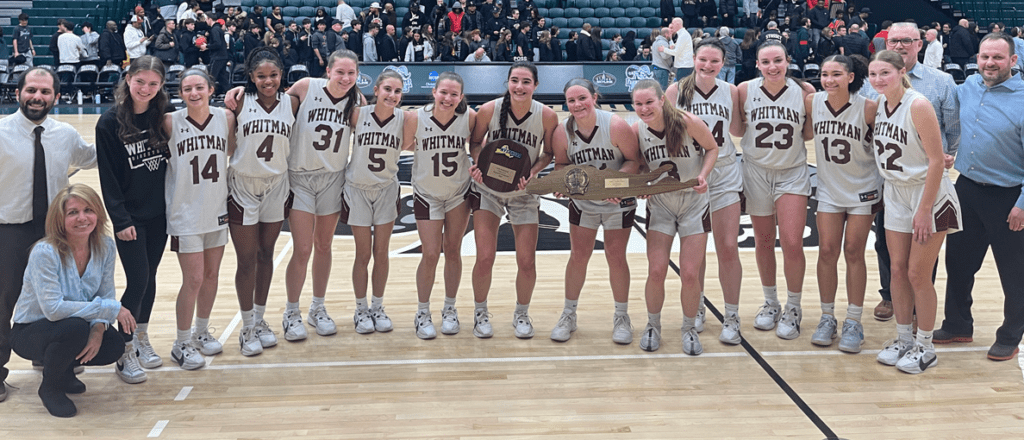 The 2024 Long Island Girls Varsity Basketball Champion team with their coaches. The players are standing in shoulder to shoulder, wearing white jerseys and holding two plagues.